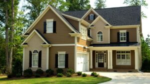 Two-story brick-and-siding luxury suburban home with a multi-gabled roof and detailed landscaping.