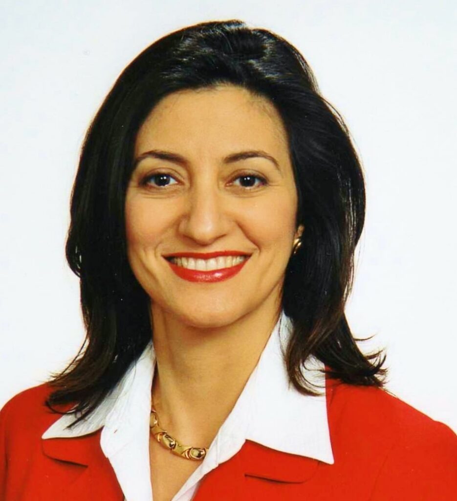 Professional headshot of West Houston realtor Lucie Ogdee, MBA, wearing a white blazer and smiling.