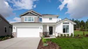 Contemporary two-story grey-and-white house with a double garage, green front yard, and clean architectural lines.