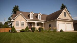 Traditional two-story siding house with a spacious front porch and gabled rooflines.